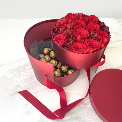 luxury round gift box with flowers arrangement and chocolate